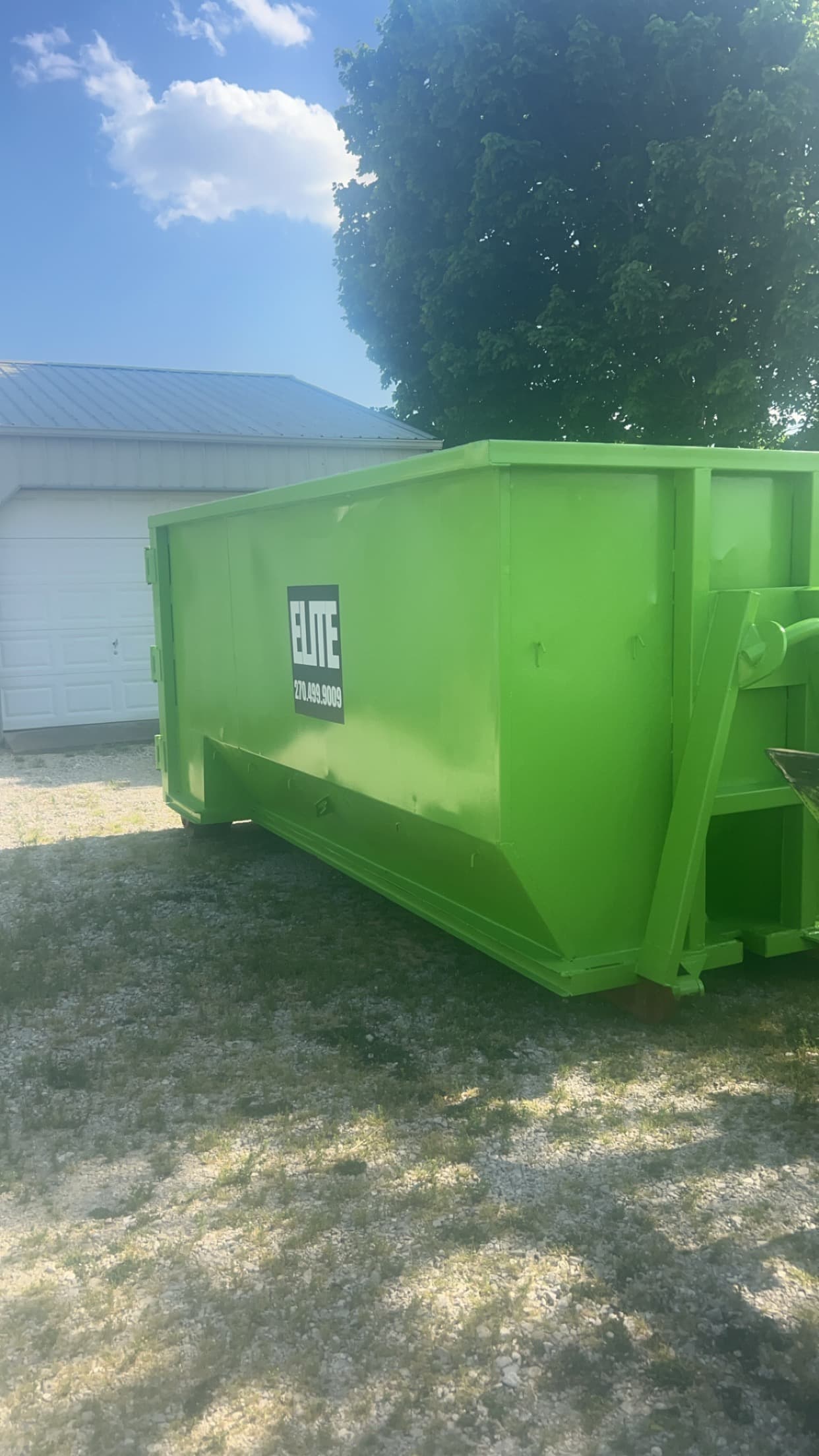 Elite Waste Services roll-off container at a Kentucky home renovation site